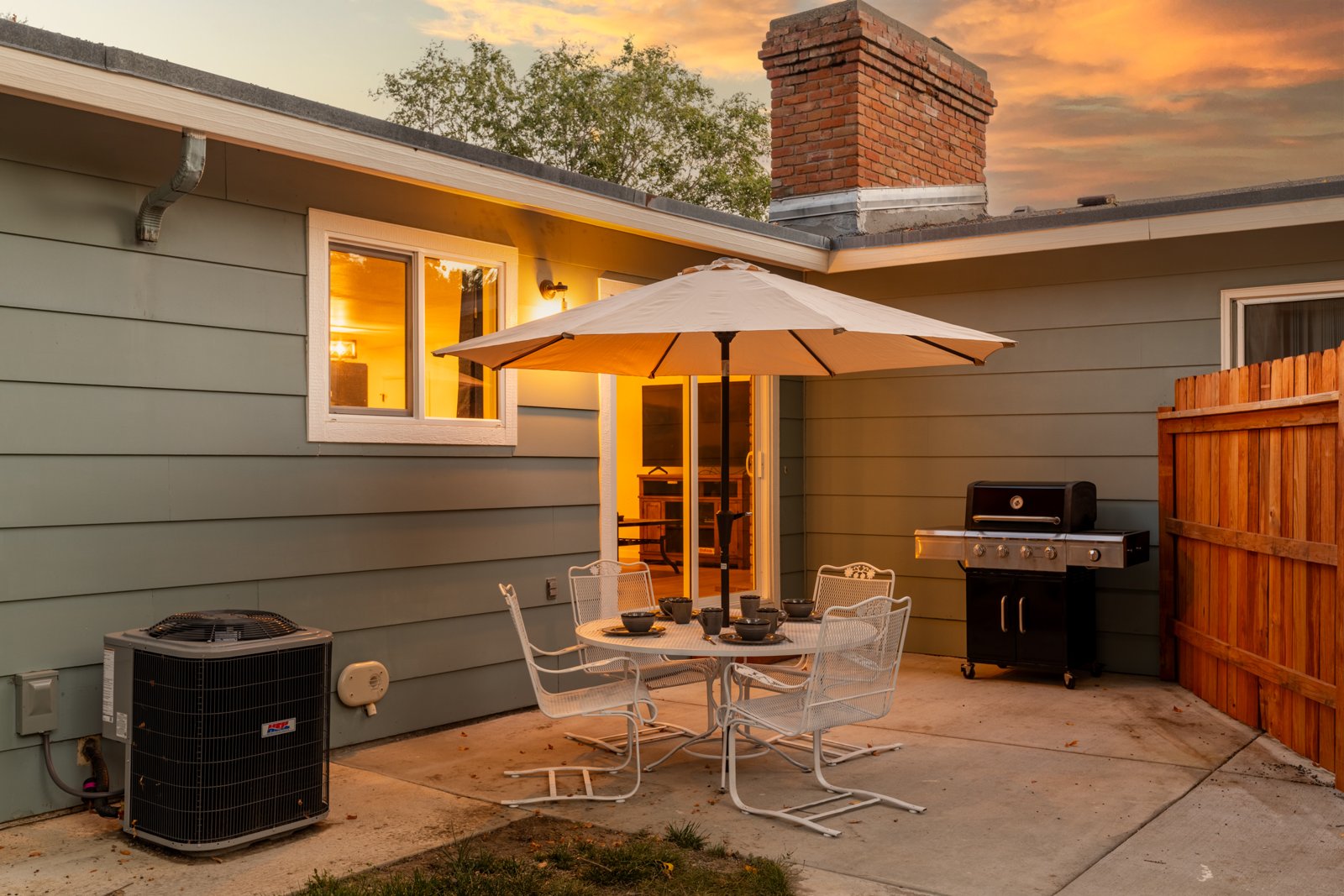 Landscaped backyard patio at twilight